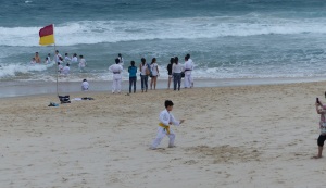 This group of a Brisbane based Japanese family karate group took a plunge in the ocean in full kit as part of their training. Note the young man still testing his skills while his mates soak up the surf.