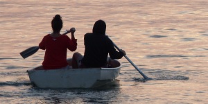These girls are totally uncoordinated trying to paddle to friends waiting on a yacht in Frenchmans Bay.