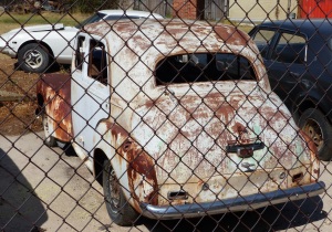 A mechanic shop/panel beater/spray painter at Coolah had a great many old cars dating from around the 1950's. This looks like a Vanguard. Then again it could be another British motor car. Anybody know what it is?
