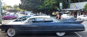 Donnis inspects a Cadillac in the street at Eumundi. Donnis grew up in a family which always had a Caddie.
